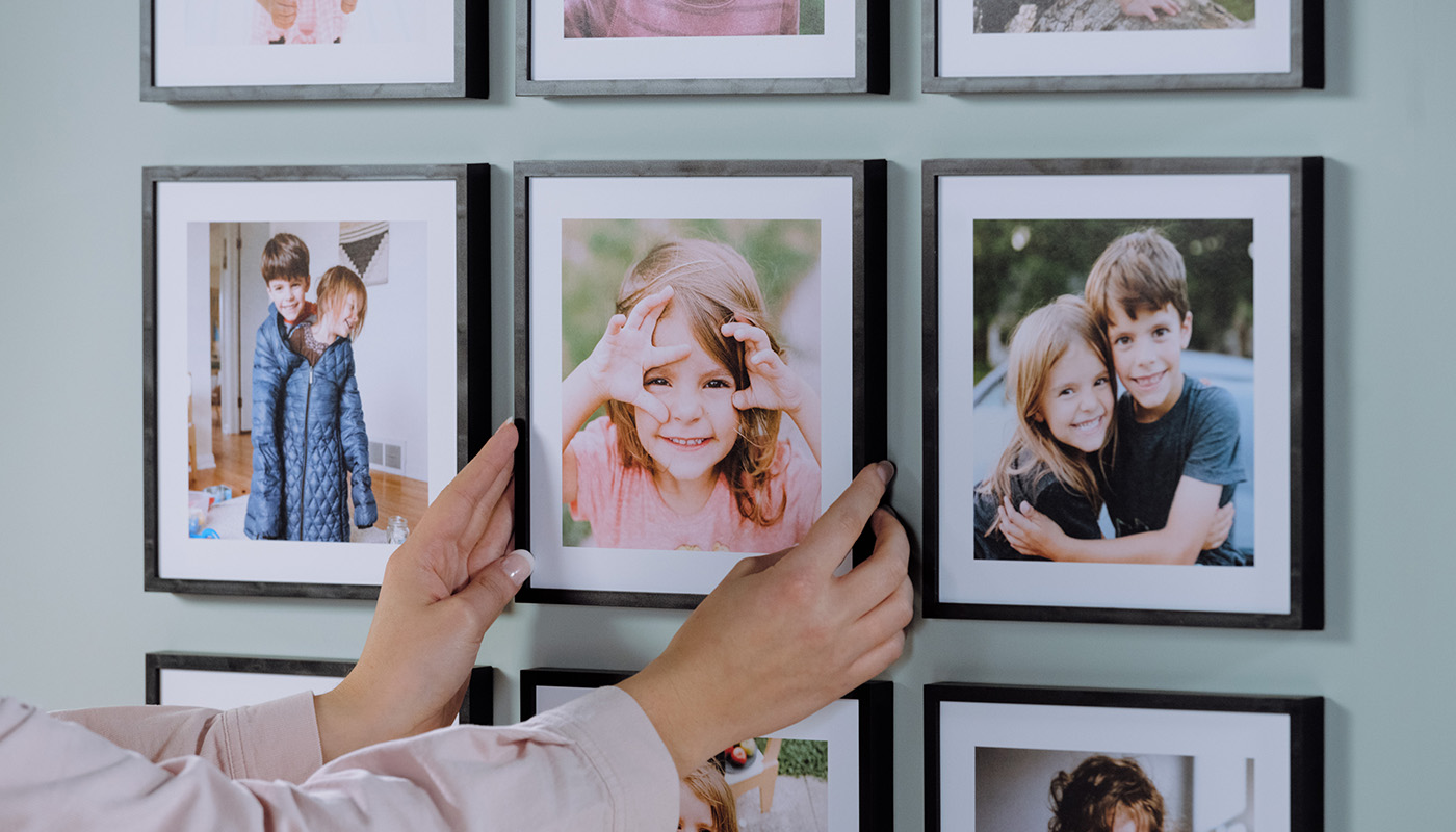 Popsa photo tiles being hung on wall