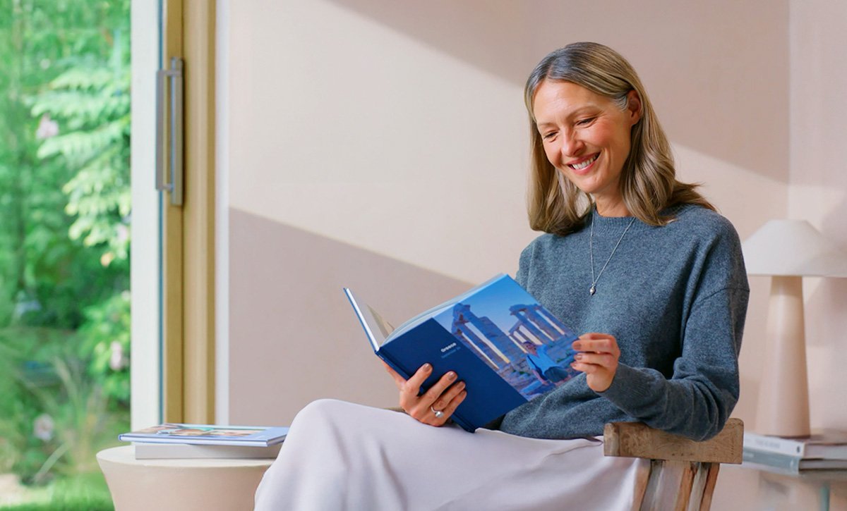 Lady browsing a Popsa Photo Book at home